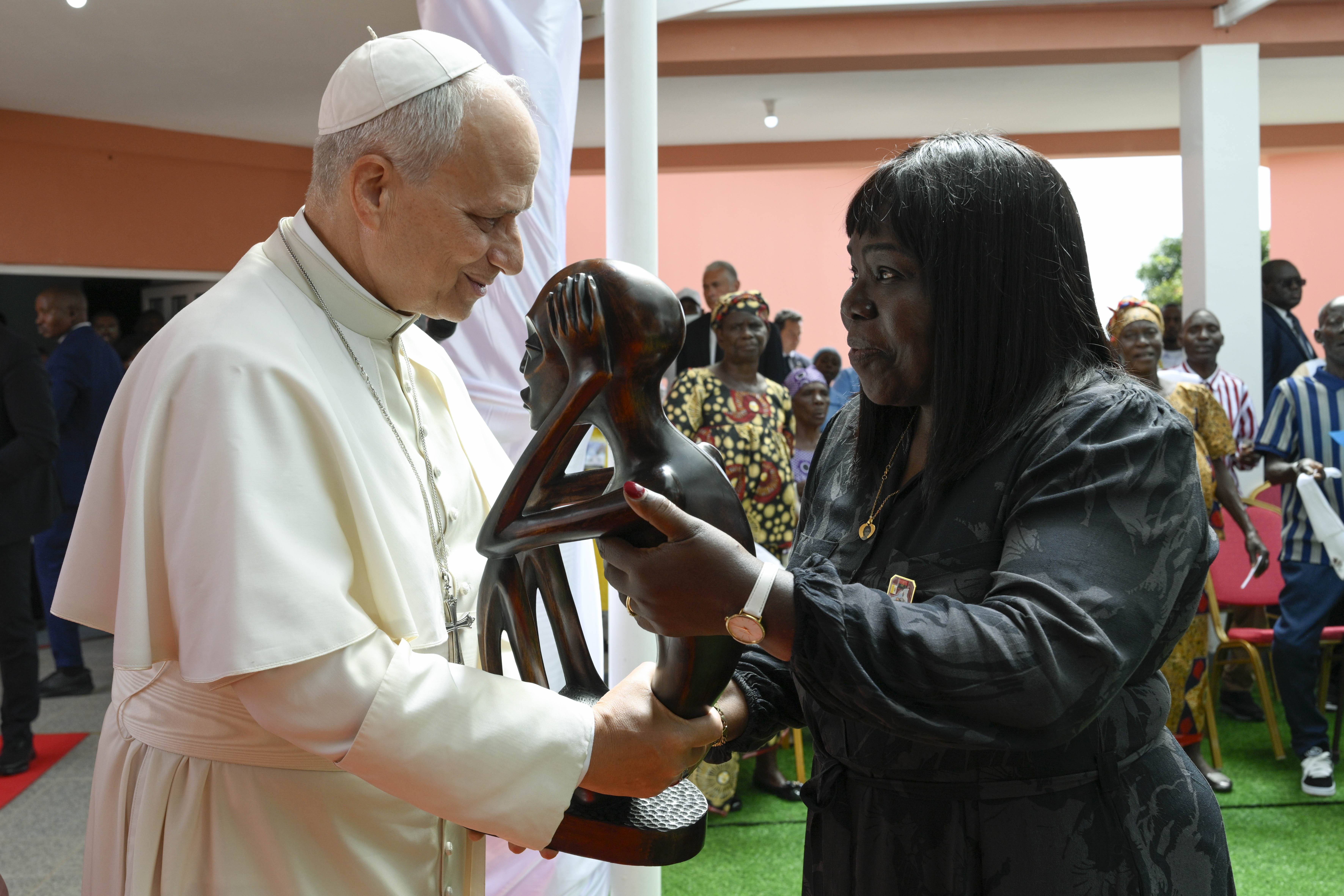 Pope Leo XIV receives a gift during his visit to a nursing home in Saurimo, Angola, on April 20, 2026. | Credit: Vatican Media