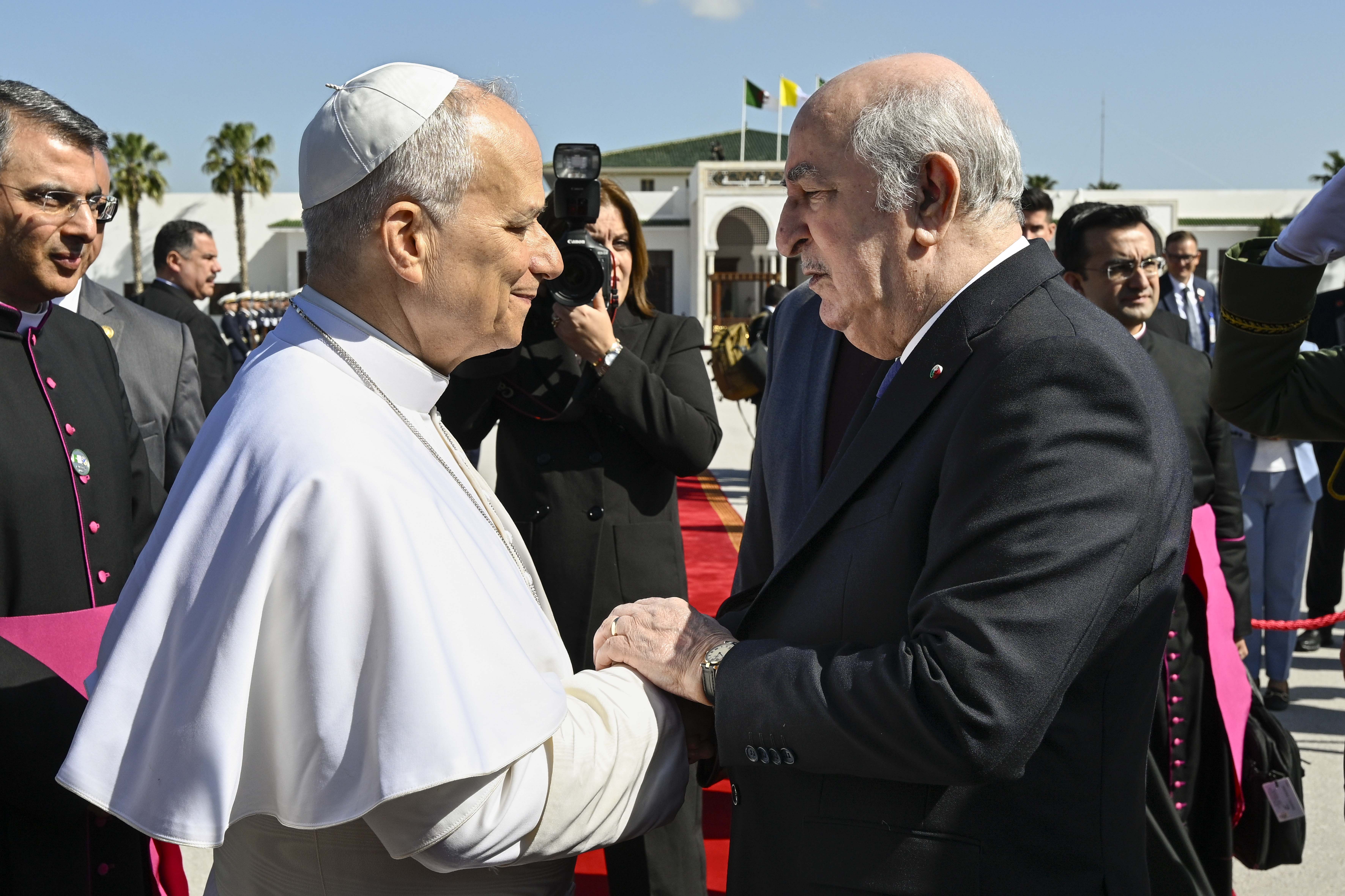 Pope Leo XIV shakes hands with Algerian President Abdelmadjid Tebboune at Houari Boumediene International Airport before departing Algeria, Wednesday, April 15, 2026. | Credit: Vatican Media