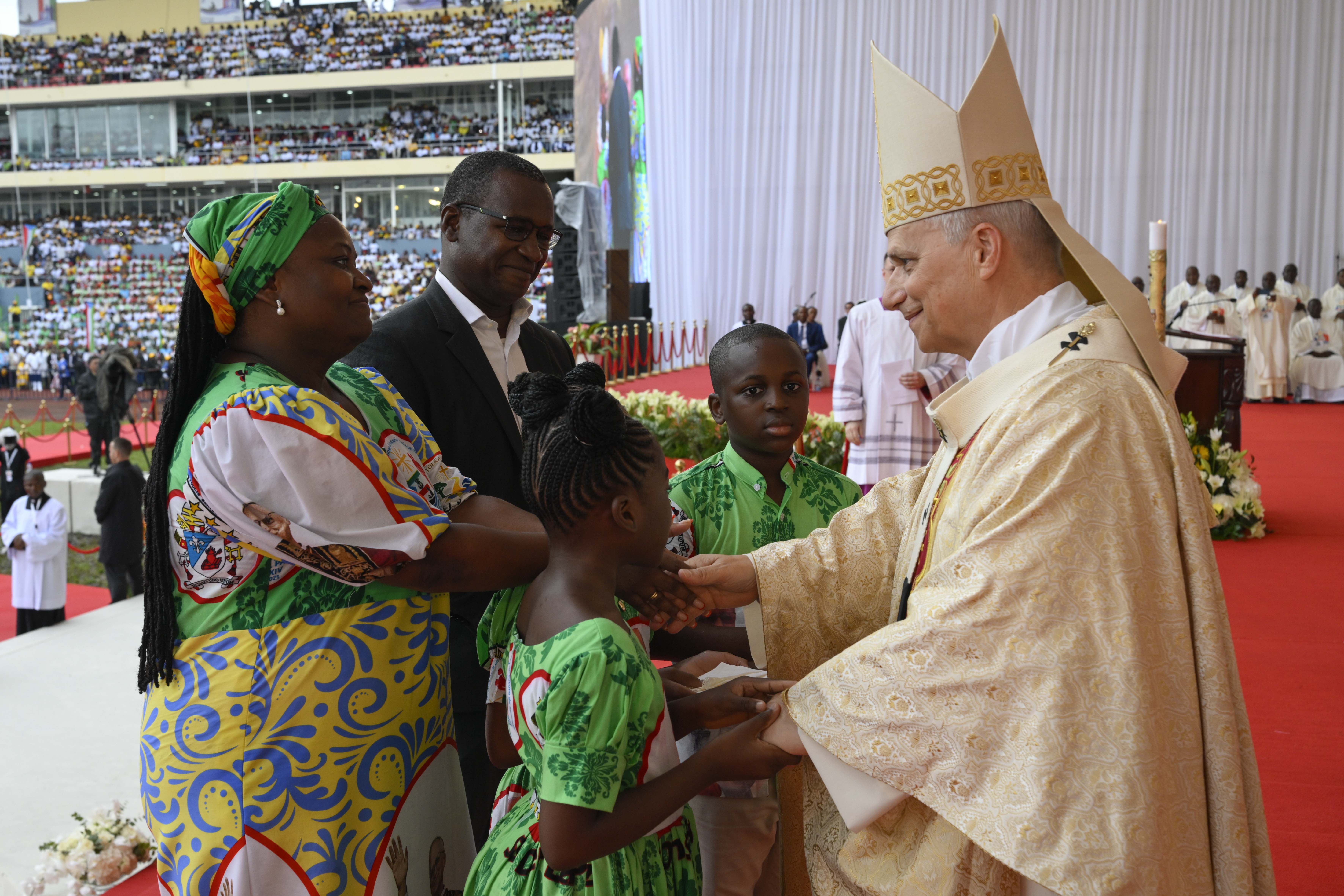 Pope Leo XIV greets a family during Mass at Malabo Stadium in Equatorial Guinea, Thursday, April 23, 2026. | Credit: Vatican Media