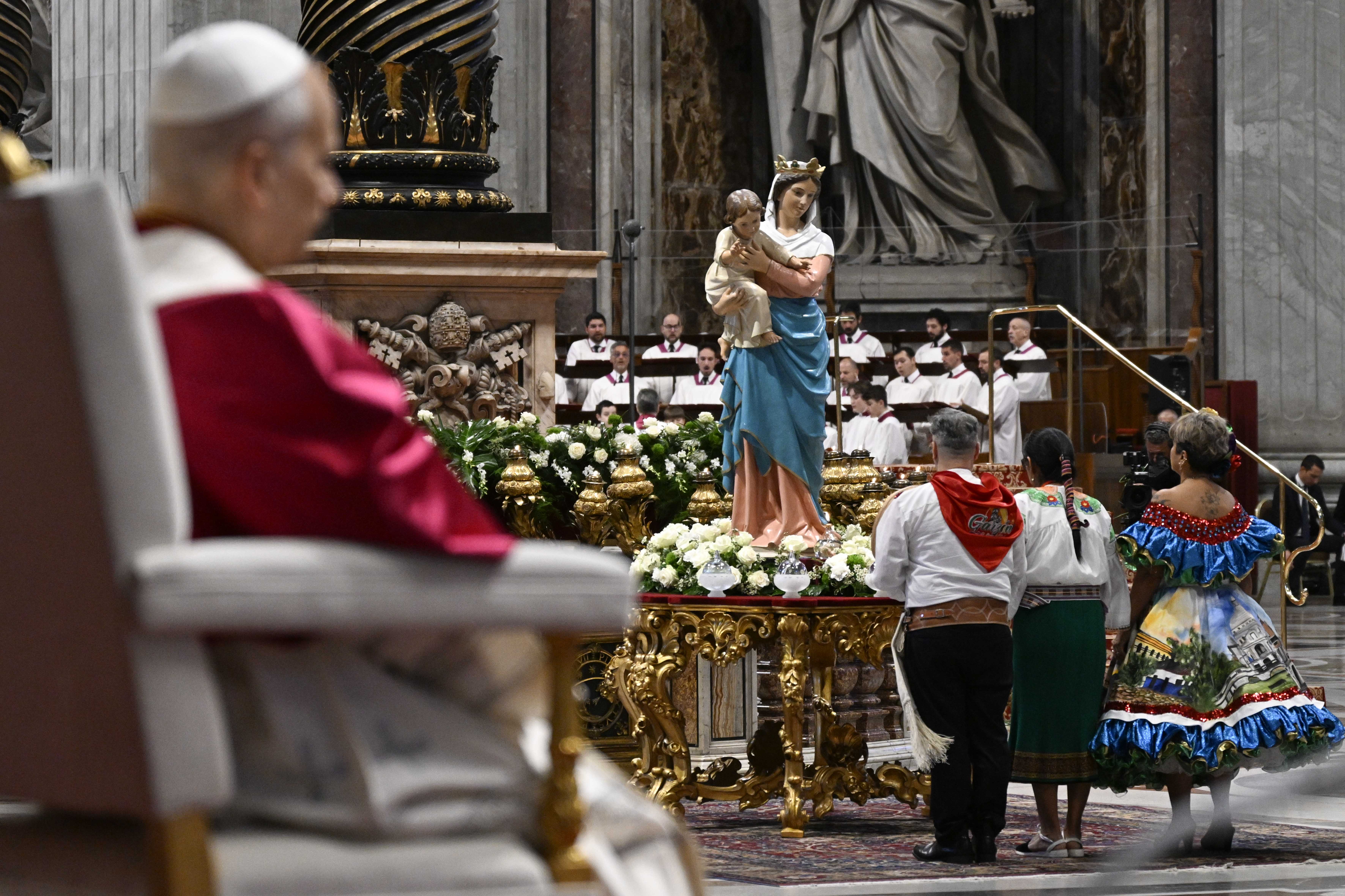 Continental delegates light a candle at the food of a statue of the Blessed Mother during a peace vigil at St. Peterʼs Basilica, Saturday, Apr. 11, 2026. | Credit: Vatican Media