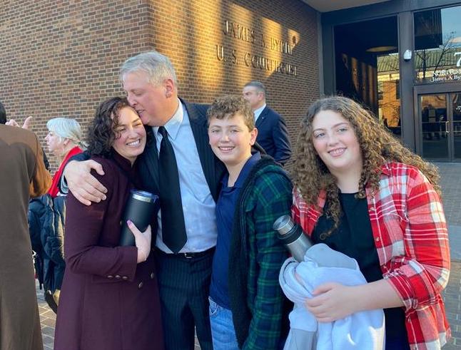 After being acquitted of federal charges by a jury in Philadelphia on Monday, Jan. 30, 2023, Mark Houck embraces and kisses his wife, Ryan-Marie Houck. Also with Houck are his son Mark Houck Jr., 14, and his daughter, Ava Houck, 12. | Credit: Joe Bukuras/EWTN News