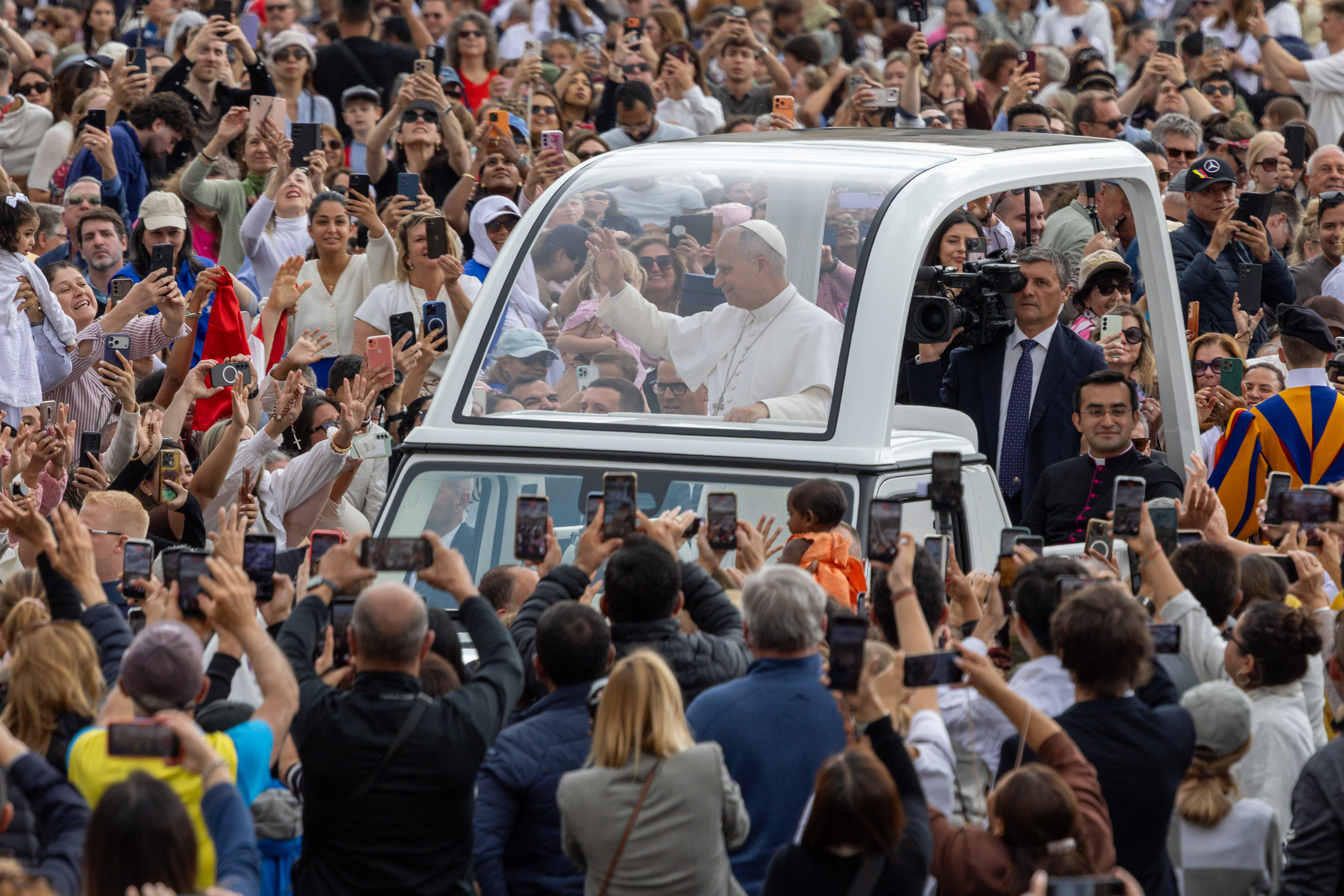 Pope Leo XIV waves at crowds of people as he circles St. Peter’s Square in the popemobile before his weekly general audience on May 13, 2026. | Credit: Daniel Ibanez/EWTN News