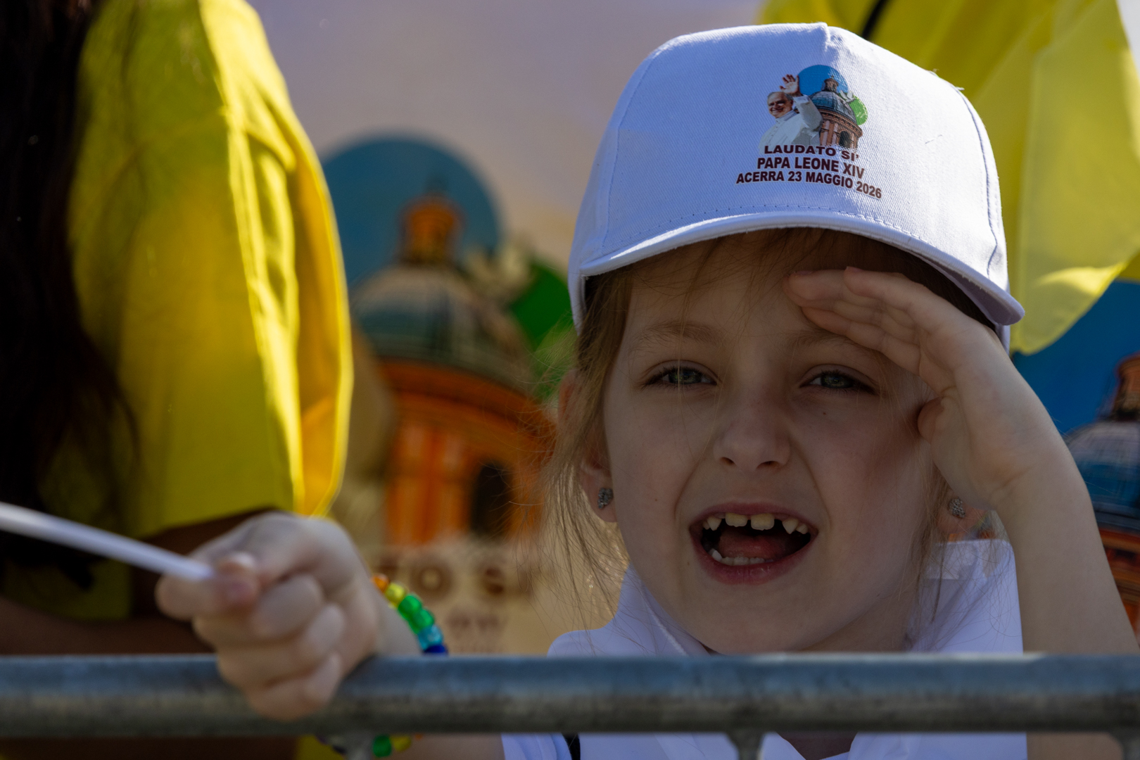 A child smiles excitedly during Pope Leo XIVʼs address in the Piazza Calipari in Acerra, Italy, May 23, 2026. The pope was visiting the “Land of Fires,” a region in southern Italy devastated by illegal waste dumping. | Credit: Daniel Ibáñez/EWTN News
