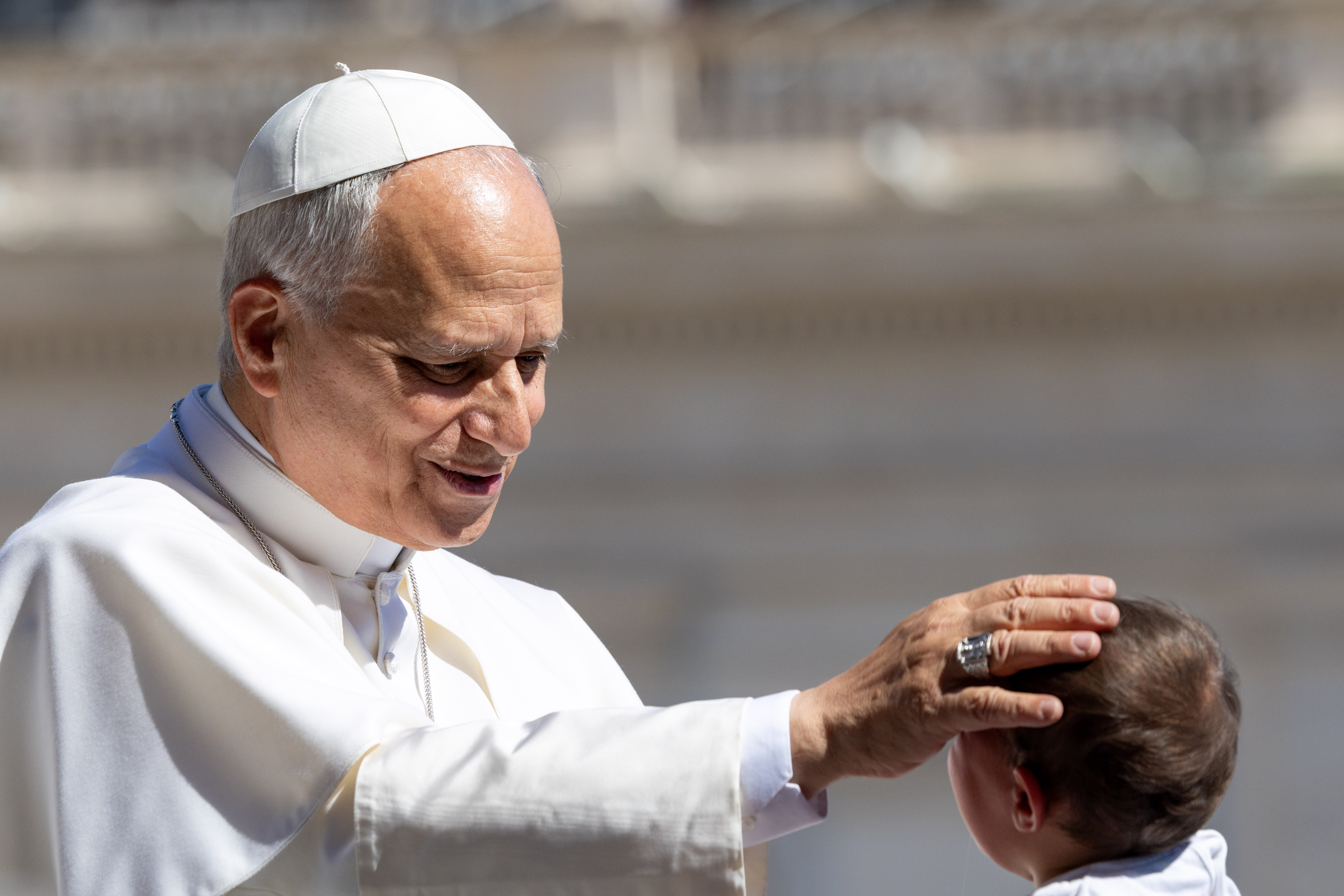 Pope Leo XIV blesses a baby in St. Peterʼs Square during the general audience on May 27, 2026. The pope spoke about the Second Vatican Council and the need for priests to follow liturgical norms. | Credit: Daniel Ibáñez/EWTN News