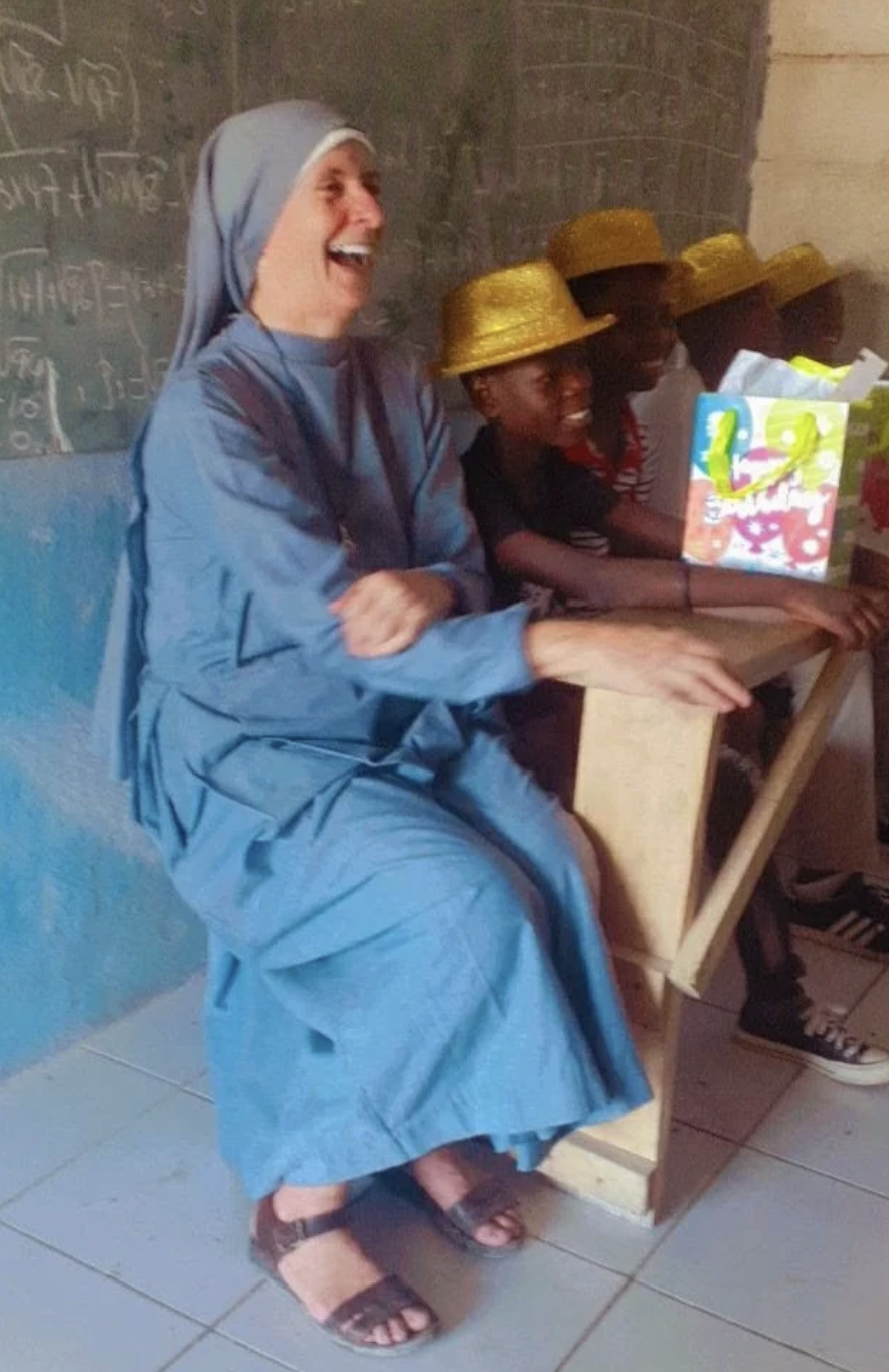 Sister Paesie and some of the Kizito Family schoolchildren. | Credit: Photo courtesy of Sister Paesie