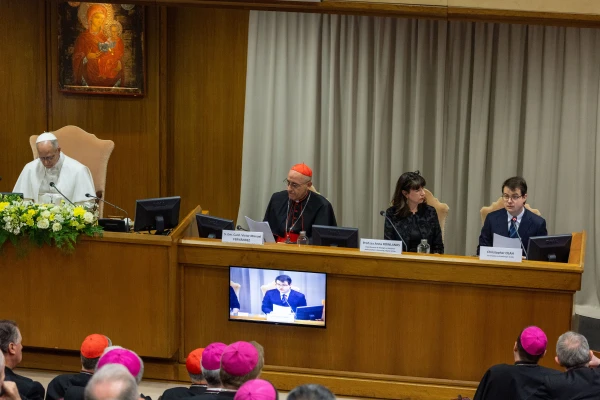 Pope Leo XIV listens to Anthropic co-founder Christopher Olah, far right, during the presentation of the pope’s first encyclical, “Magnifica Humanitas: On the Safeguarding of the Human Person in the Age of Artificial Intelligence,” at the Vatican’s Synod Hall on May 25, 2026. | Credit: Daniel Ibáñez/EWTN News