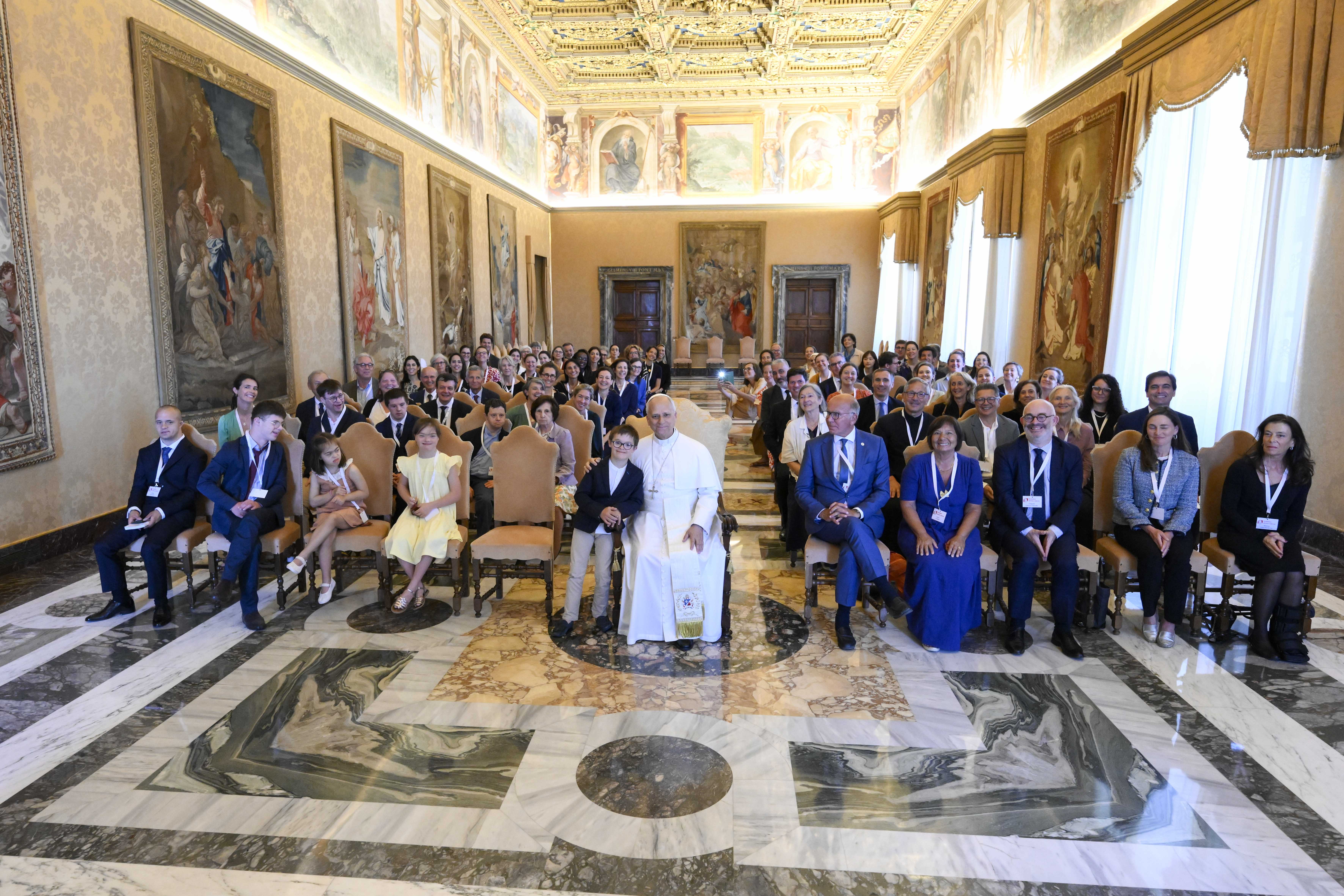 Pope Leo XIV takes a photo with members of the Jérôme Lejeune Foundation in the Apostolic Palace at the Vatican on June 22, 2026. | Credit: Vatican Media