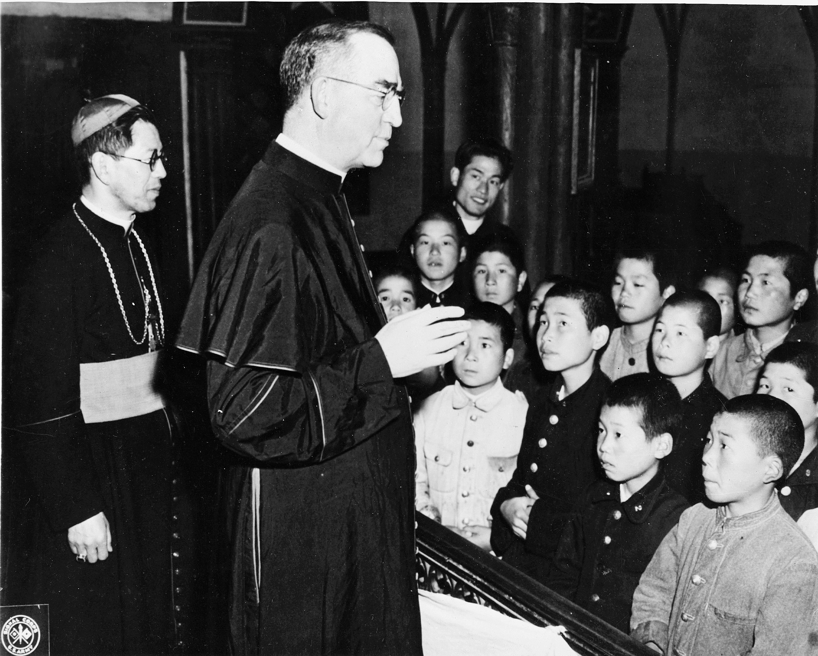 Father Edward J. Flanagan speaking to children with the priest of Nagasaki Oura Church in Japan. Photo courtesy of Boys Town.