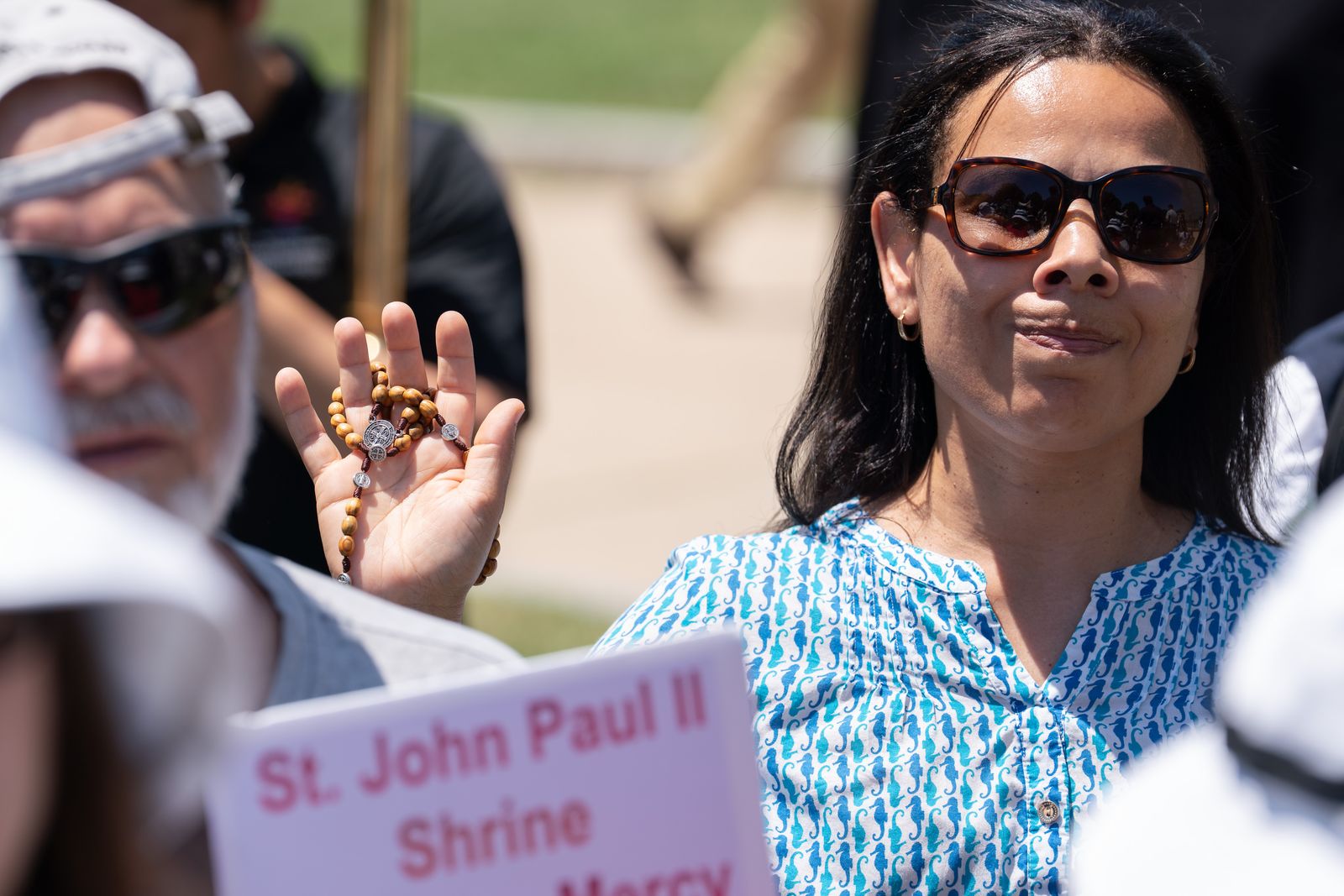 A Catholic prays with a rosary during a Eucharistic procession in Boston, June 27, 2026. The event was part of the National Eucharistic Pilgrimage taking place up and down the East Coast. | Credit: Bryce Vickmark