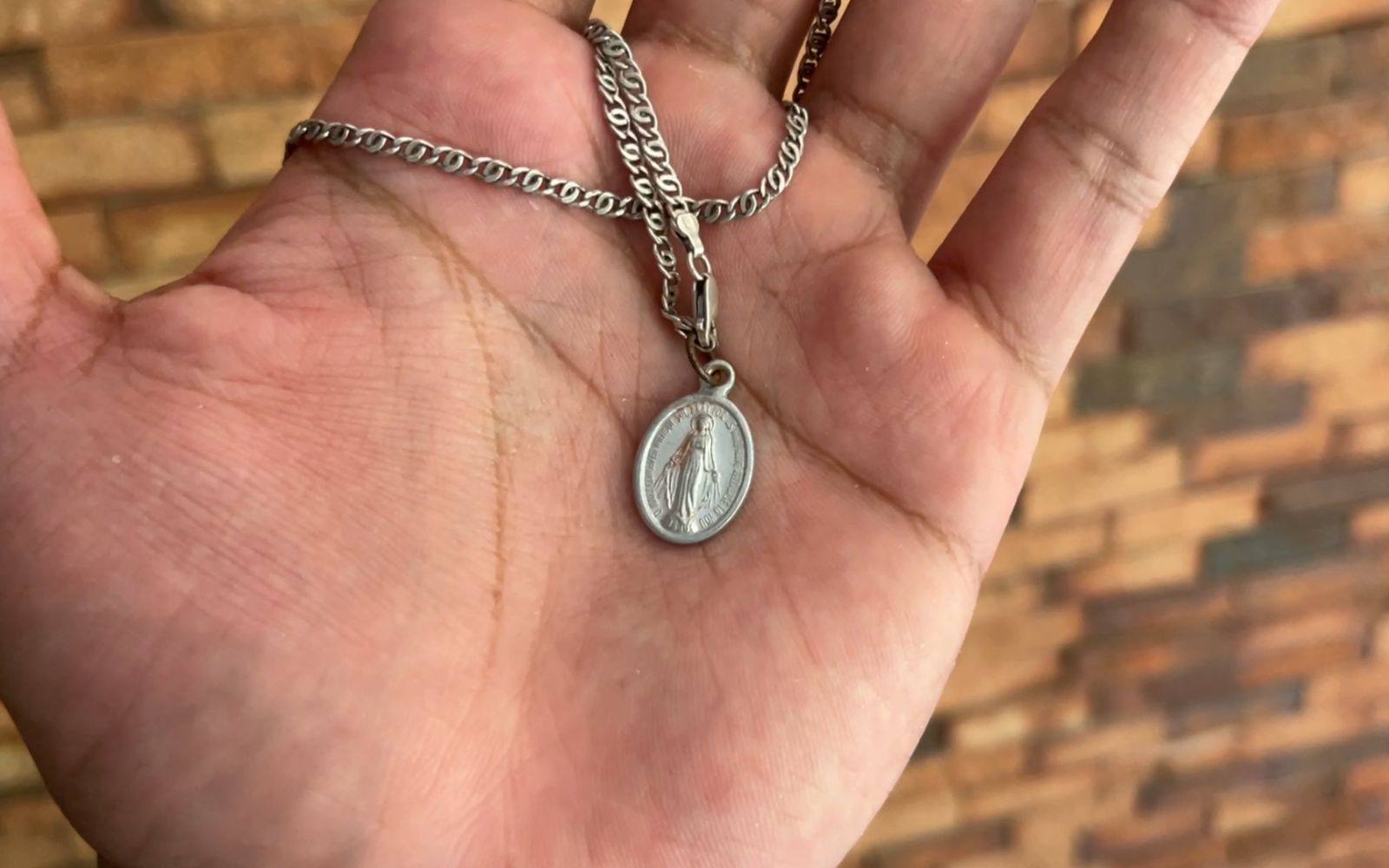 The Miraculous Medal that Kamar Galíndez wore around his neck, which broke during the collapse and later appeared — inexplicably — in the pocket of his shorts. | Credit: Andrés Henríquez/EWTN News