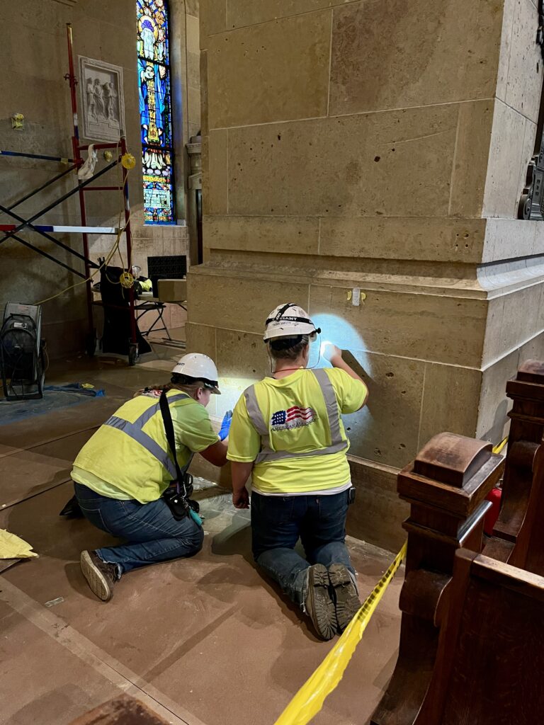 Workers in an undated photograph clean a limestone surface in an ambulatory of the Basilica of Saint Mary in Minneapolis. | Credit: Photo courtesy of the Basilica of Saint Mary