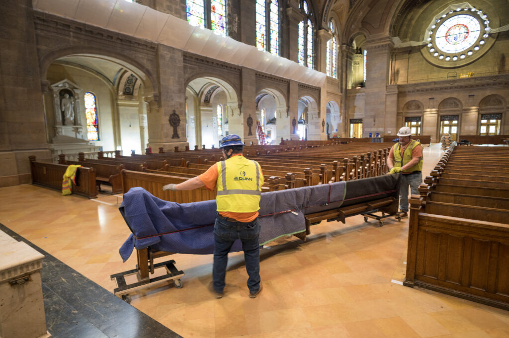Workmen in an undated photo remove pews from the Basilica of Saint Mary in Minneapolis as part of the restoration of the church. | Credit: Ken Fournelle/Courtesy of the Basilica of Saint Mary
