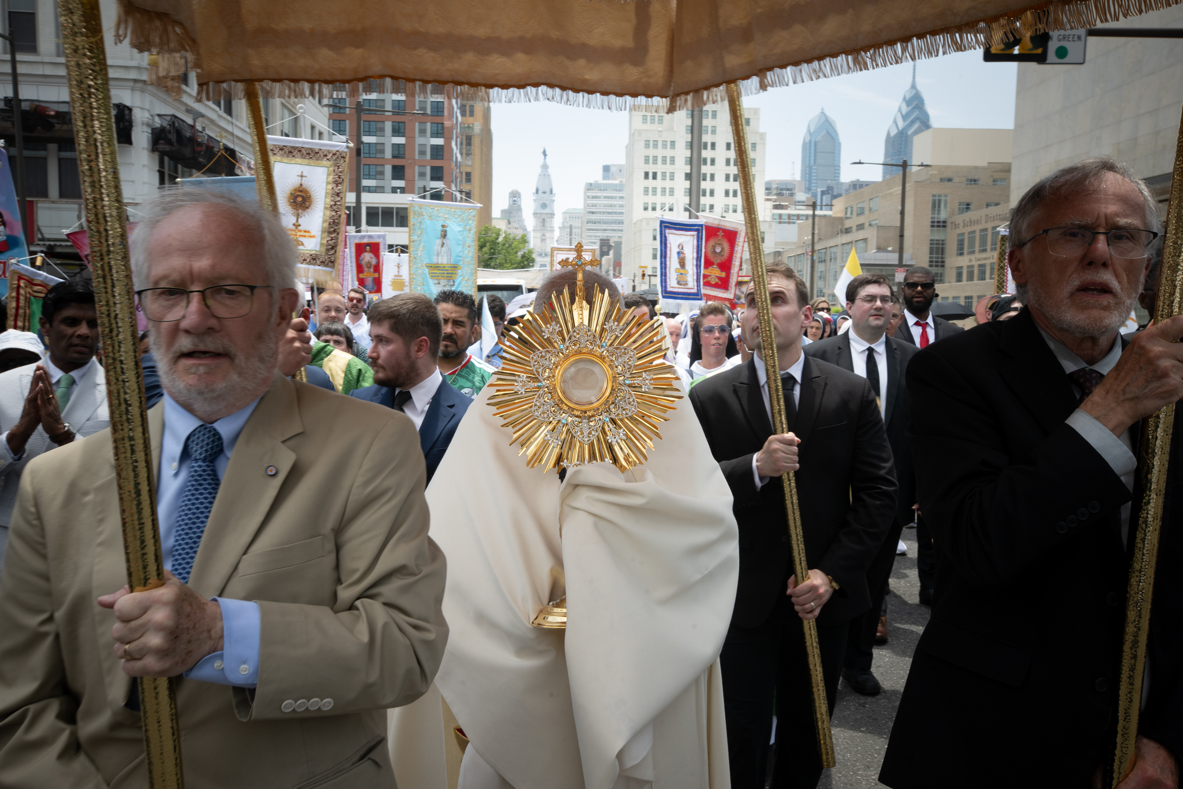 Archbishop Nelson J. Pérez carries the Blessed Sacrament beneath a canopy as pilgrims follow through the streets of Philadelphia during the 2026 National Eucharistic Pilgrimage, Sunday, July 5, 2026. | Credit: Jeffrey Bruno