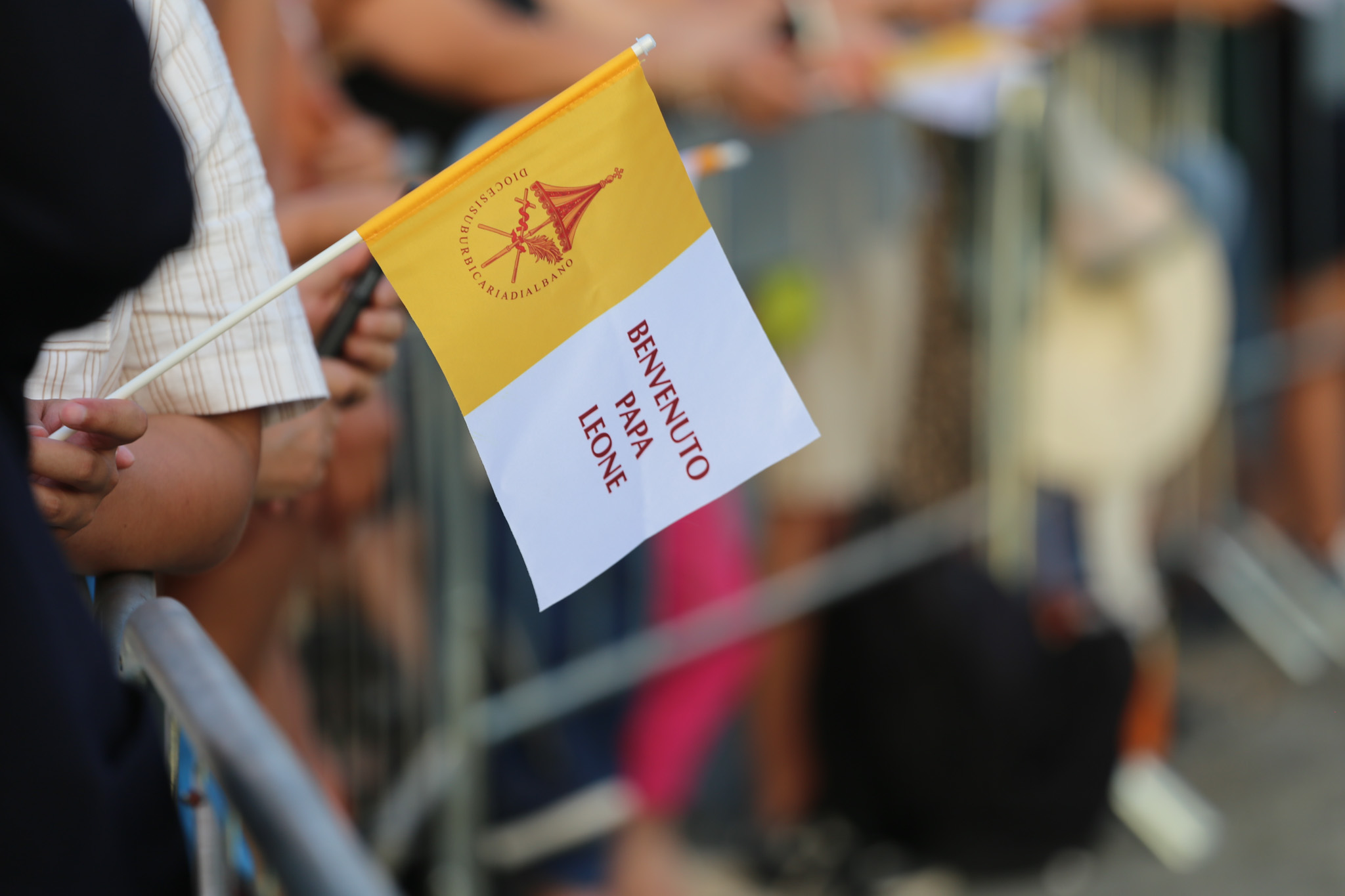 A pilgrim waves a flag welcoming Pope Leo XIV to Lake Albano at Castel Gandolfo, Aug. 29, 2026. Leo took part in a Marian procession on the lake, becoming the first pope to travel by boat across the waters there according to the Vatican. | Credit: Zofia Czubak/EWTN News