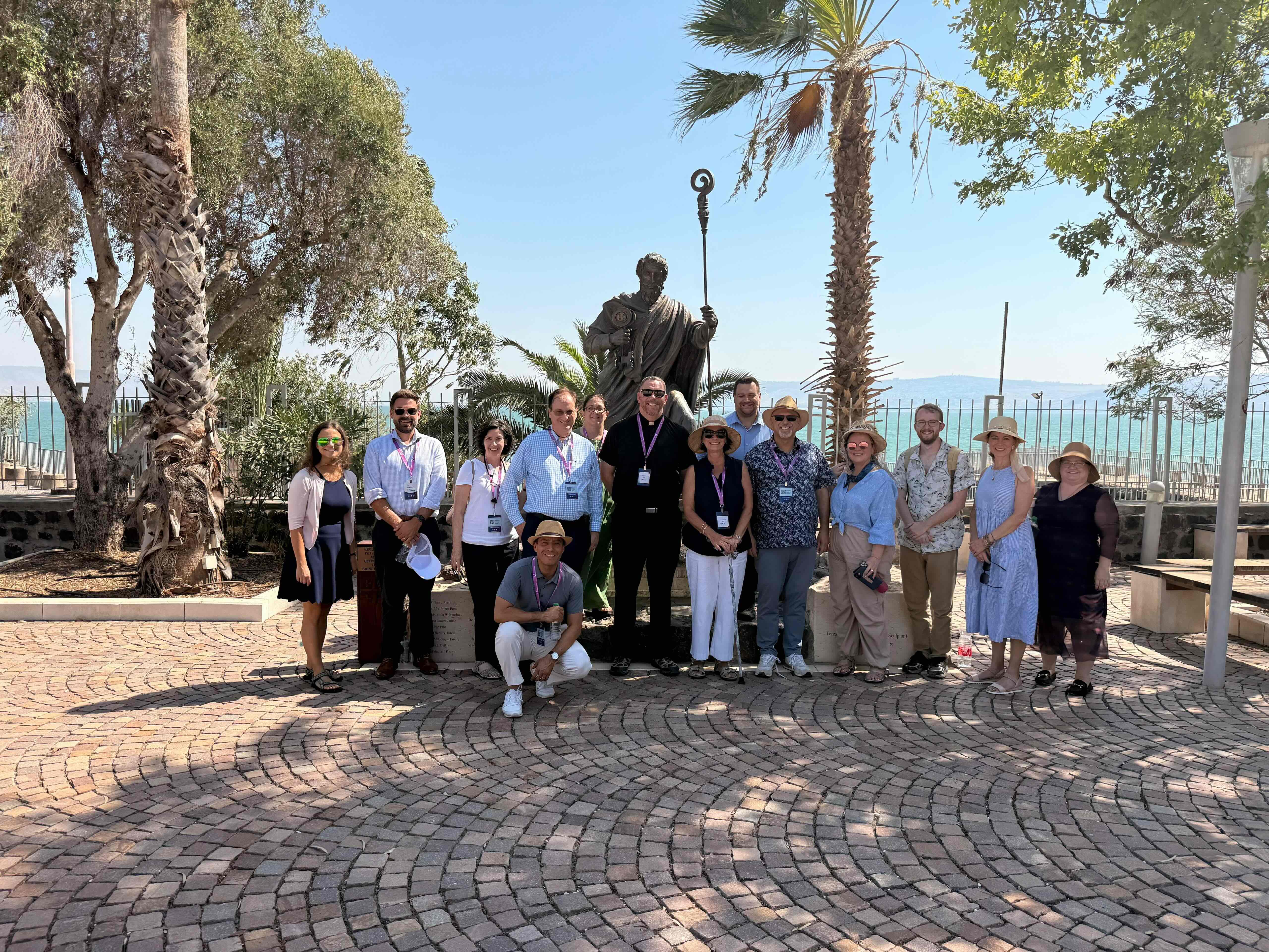 With St. Peter’s statue towering above them, members of the delegation are seen here in Capernaum, the fishing village that was the primary base of operations of Jesus’ ministry in Galilee and home of the Chief of the Apostles. | Credit: Photo courtesy of Yosi Shoshani