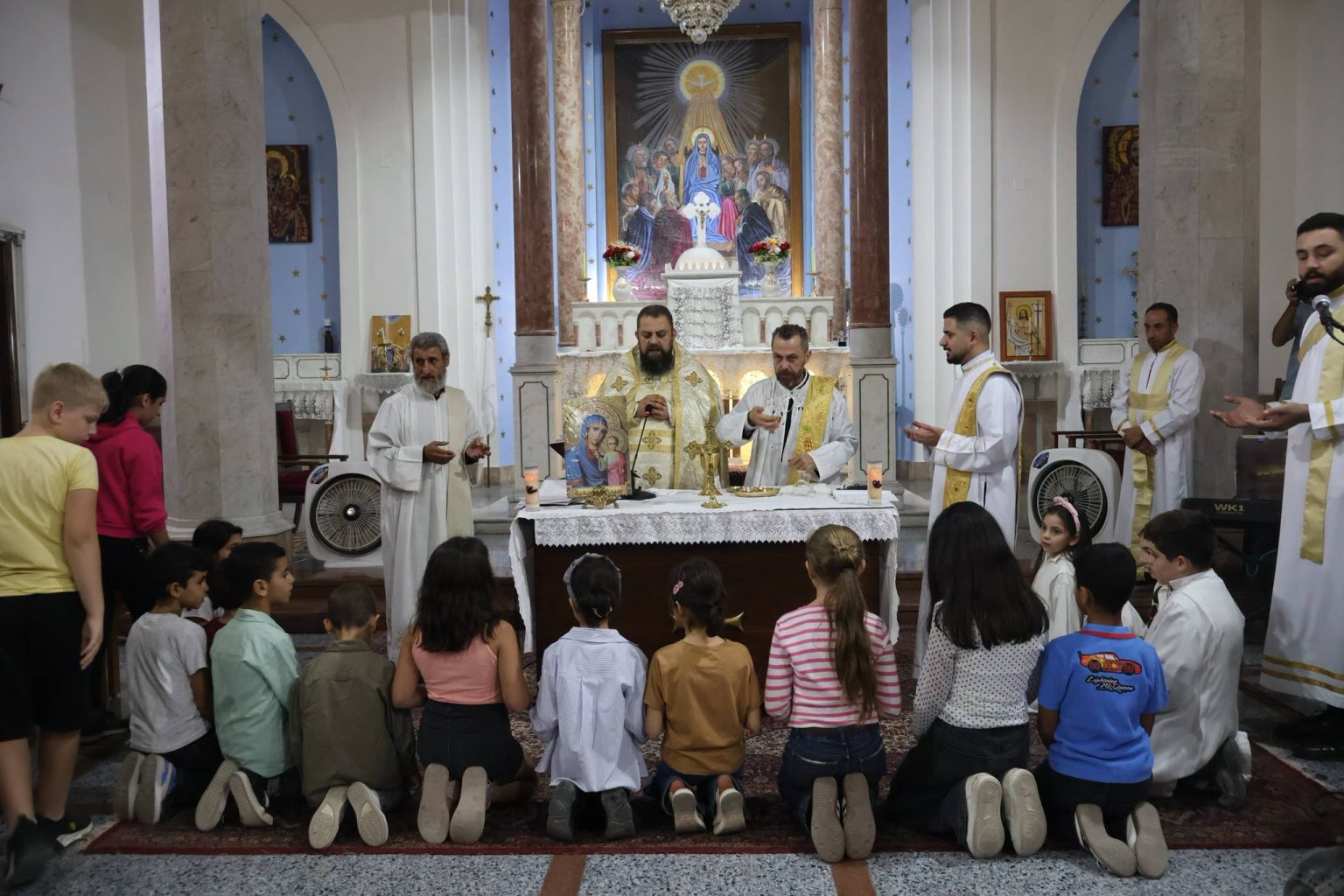 Children gather before the altar in Homs, Syria. | Credit: Photo courtesy of the Syriac Catholic Archeparchy of Homs, Hama, and Nabk
