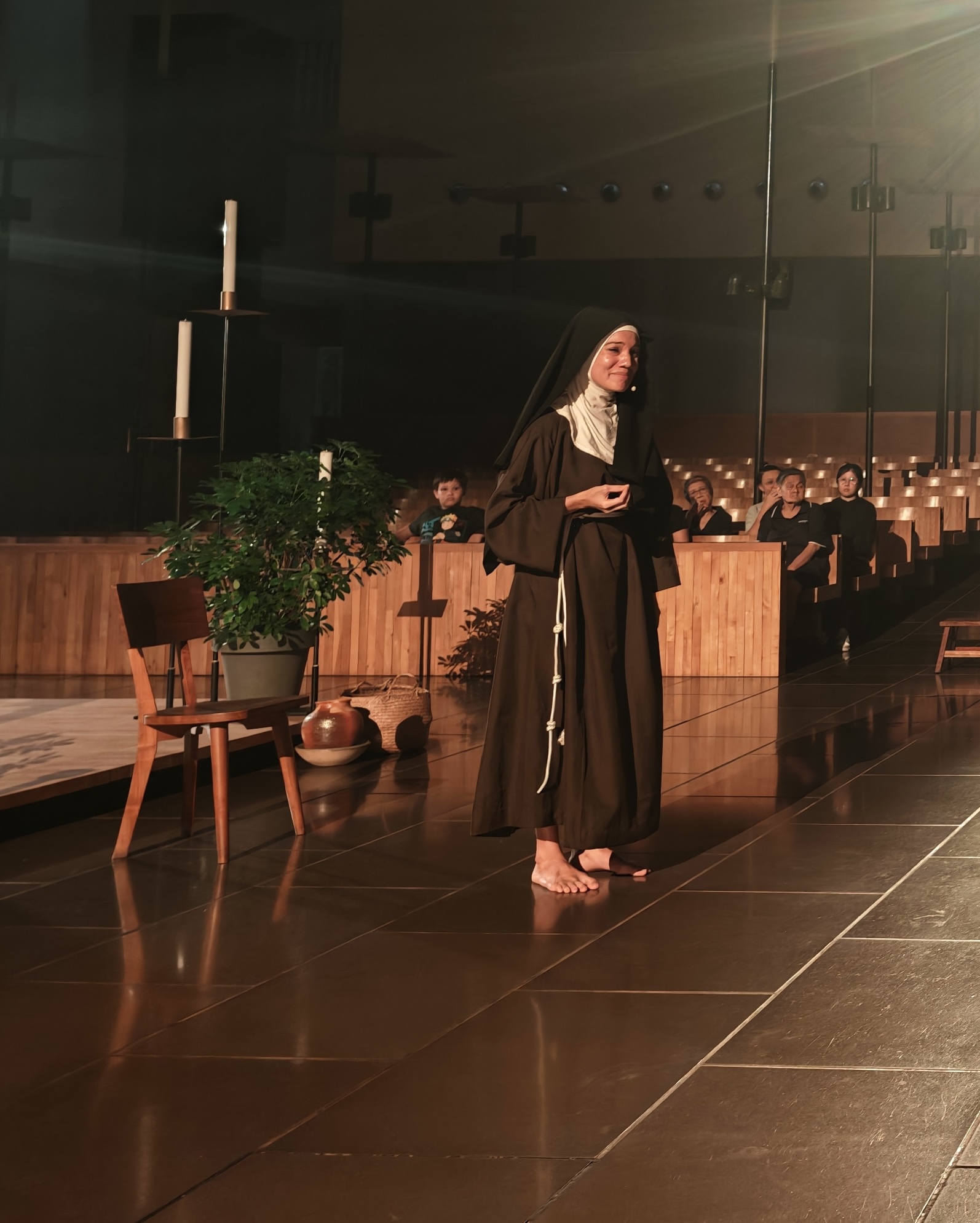 Sharda Harrison, barefoot, addresses the audience as St. Clare at the first performance of “TO GAZE: St. Clare of Assisi,” Oct. 16, 2026. | Credit: Benedict Tang