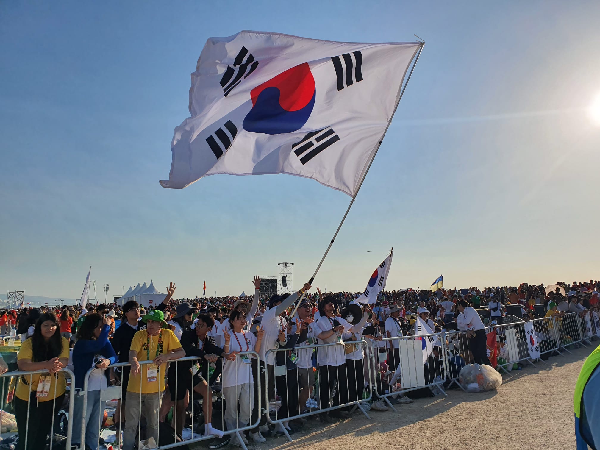 Pilgrims from South Korea wave a flag at the closing Mass of World Youth Day Lisbon with Pope Francis on Aug. 6, 2023. | Credit: Hannah Brockhaus/EWTN News